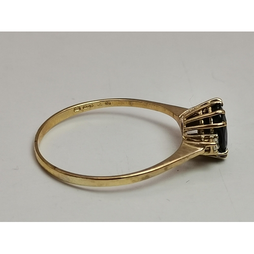 548A - A 9 carat gold five stone ring, with three graduated round blue stones spaced by two round white sto... 