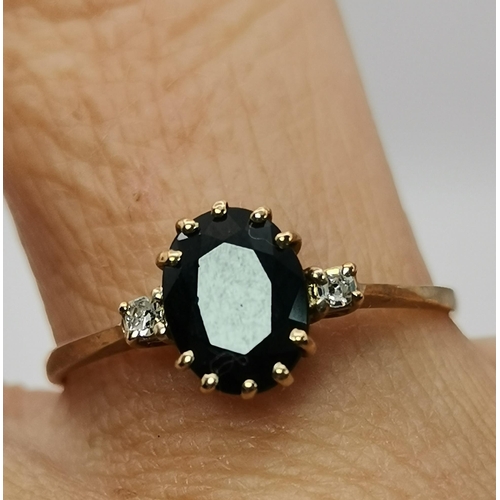 548A - A 9 carat gold five stone ring, with three graduated round blue stones spaced by two round white sto... 