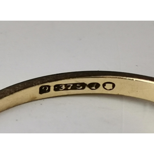 548A - A 9 carat gold five stone ring, with three graduated round blue stones spaced by two round white sto... 