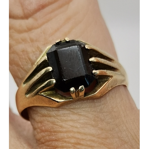 559A - Three 9 carat gold garnet solitaire rings, each with a claw-mounted stone, two rectangular and one o... 