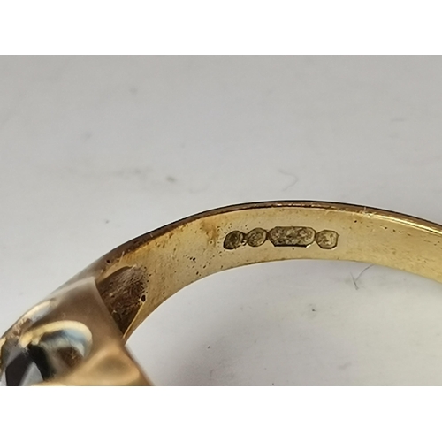 559A - Three 9 carat gold garnet solitaire rings, each with a claw-mounted stone, two rectangular and one o... 