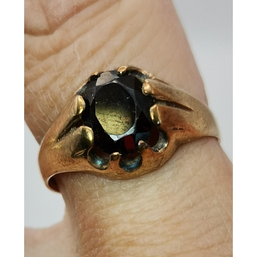 559A - Three 9 carat gold garnet solitaire rings, each with a claw-mounted stone, two rectangular and one o... 