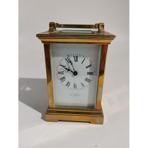 71 - A brass carriage clock with enamel face made by t and j perry regent street london