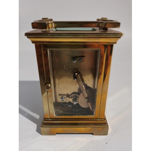 71 - A brass carriage clock with enamel face made by t and j perry regent street london