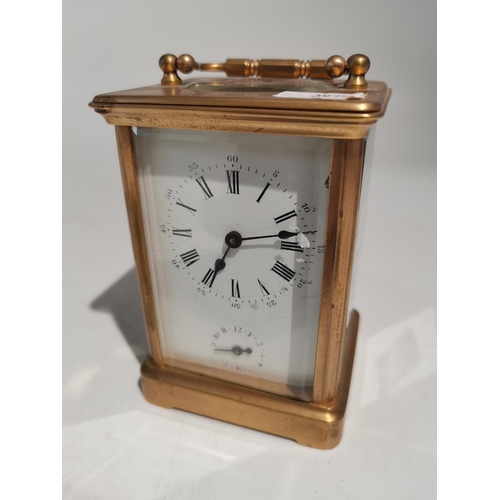73 - A brass carriage clock with enamel face and having a seconds hand