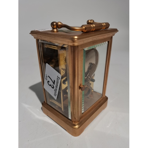 73 - A brass carriage clock with enamel face and having a seconds hand