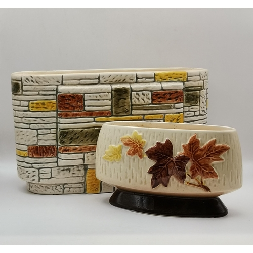 81 - Two pieces of Sylvac pottery, an oval 'brick wall' planter, no. 3653, impressed marks to base; and a... 