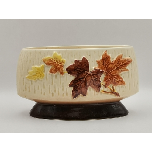 81 - Two pieces of Sylvac pottery, an oval 'brick wall' planter, no. 3653, impressed marks to base; and a... 
