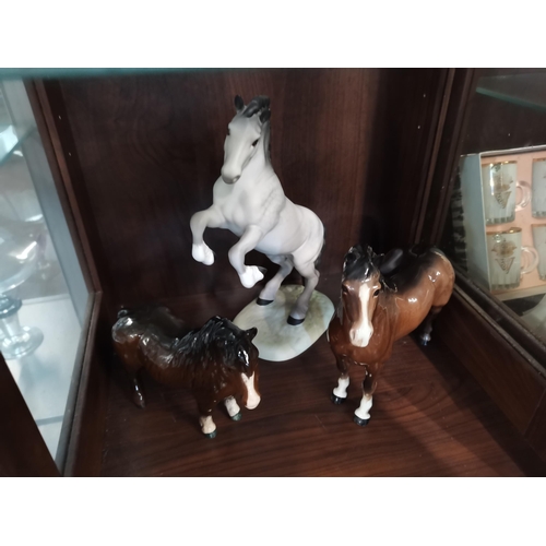 95 - A Beswick Welsh cob, rearing, model no. 1014, matt grey; together with two other pony models, brown ... 