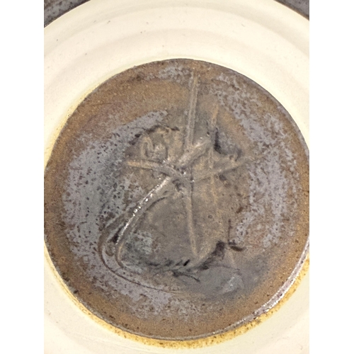 10 - Paul Winspear: A New Zealand studio pottery green glaze charger, c.1990s, with incised initials to b... 