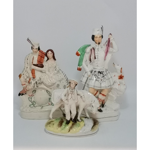 117 - Three Antique Staffordshire figurines - Flatback Highlander Couple with Clock H35cm, Large flatbacke... 