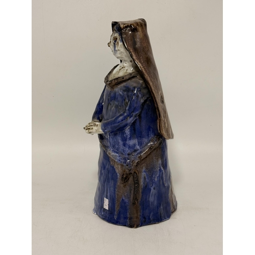 16 - A stoneware figure of a nun, possibly Portuguese, mark on base AC. Approx. 38cm high