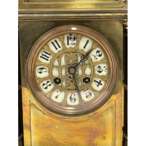 25 - A French brass cased mantel clock, 19th Century, the white enamel dial with black Arabic numerals be... 
