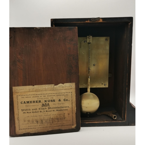 28 - A late 19th Century walnut cased mantel clock, the white enamel dial with black Roman numerals, the ... 