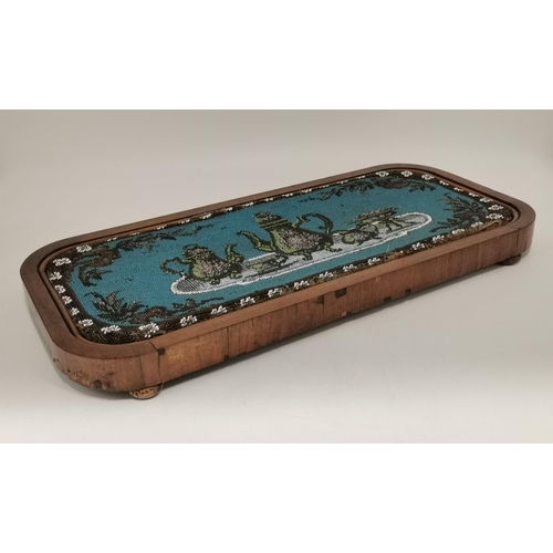 30 - A Victorian beadwork tray decorated with a green tea and coffee service to a blue ground, to a woode... 