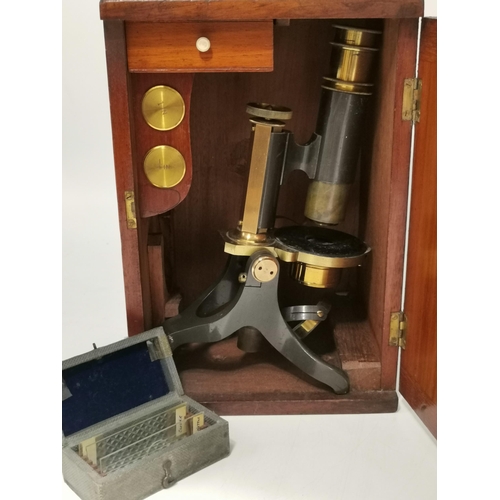39 - A Victorian Brass Microscope English c 1880, unsigned with two objectives and eyepiece in a French p... 