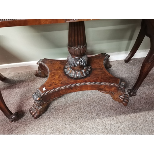 634 - A very good quality William IV burr yew wood games table with lion paw feet and highly decorative ce... 