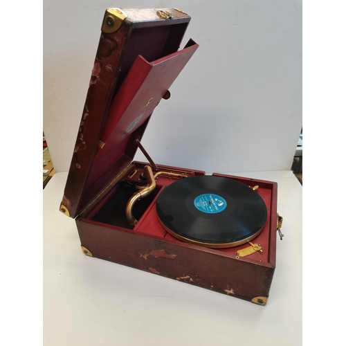 68 - A vintage HMV portable gramophone, in red leather case with gilt-metal fittings, corner spin-tray wi... 