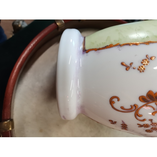 22 - An opaline glass garniture, comprising a large vase and cover together with two smaller vases, each ... 