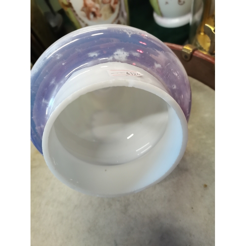 22 - An opaline glass garniture, comprising a large vase and cover together with two smaller vases, each ... 