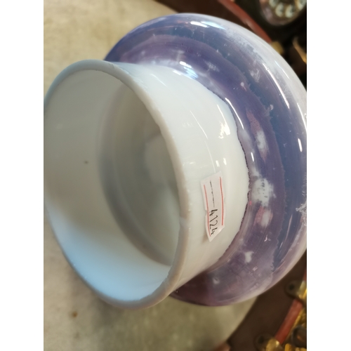 22 - An opaline glass garniture, comprising a large vase and cover together with two smaller vases, each ... 