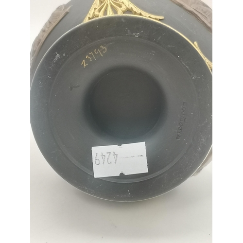 2 - Two Wedgwood vases, the first a small bottle vase, the black ground with bronzed and gilded decorati... 