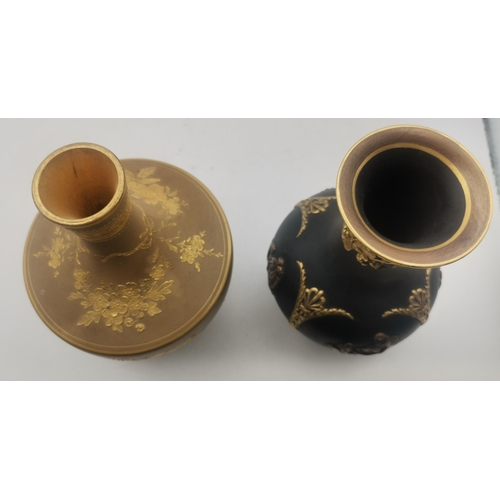 2 - Two Wedgwood vases, the first a small bottle vase, the black ground with bronzed and gilded decorati... 