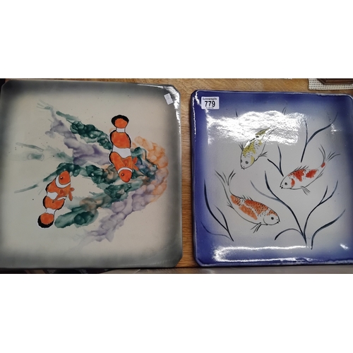 779 - A pair of Eskdale studio whitby chargers with fish decoration 35cm x 35cm