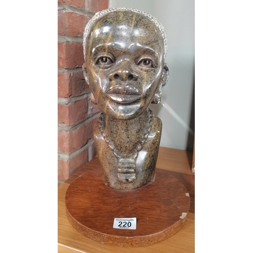 220 - A large Shona African hard stone sculpture of a woman 35cm high