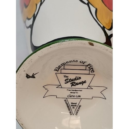 228 - Three Clarice Cliff items - coffee cup and saucer Windbells' patter, Sugar Sifter and Cup