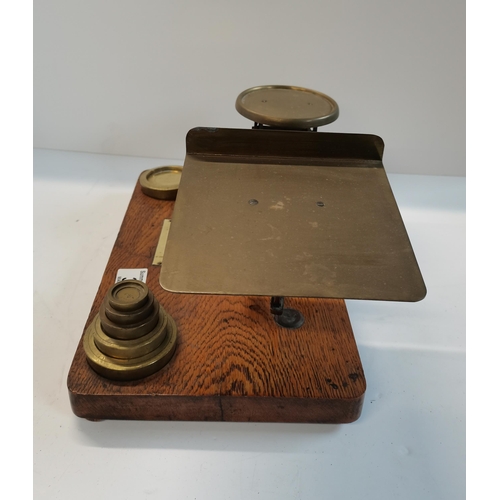 34 - Antique balance scale with wooden base and brass components and set of nesting weights