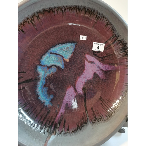 4 - A large New Zealand studio pottery purple-blue glaze charger, c.1990s, with incised signature to bas... 