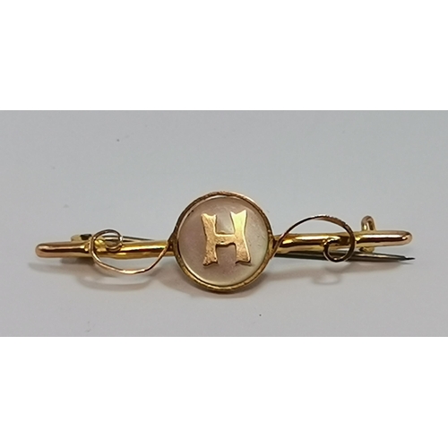589 - Four assorted 9 carat gold bar brooches, comprising a fox mask and riding crop; a mother-of-pearl di... 