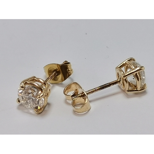 671 - A pair of yellow gold diamond stud earrings, with threaded posts, unmarked. 6mm diameter, 1.6g gross... 