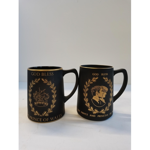 102 - Three Wedgwood black Jasperware commemorative mugs, with gilded decoration, comprising New Millenniu... 