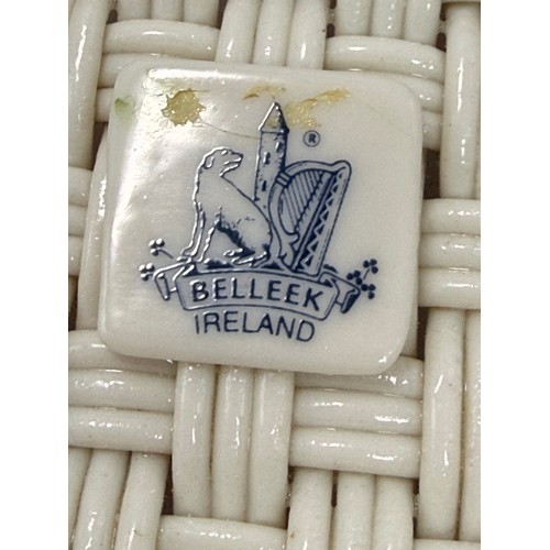 119 - Three pieces of Belleek pottery including String Bag Pot, Scroll Flower ink Irish Vase with gold rim... 
