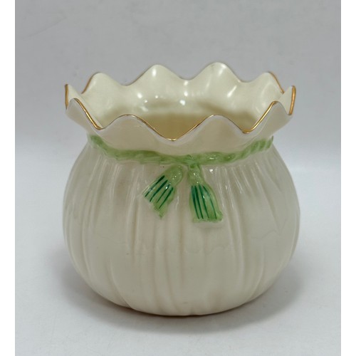 119 - Three pieces of Belleek pottery including String Bag Pot, Scroll Flower ink Irish Vase with gold rim... 