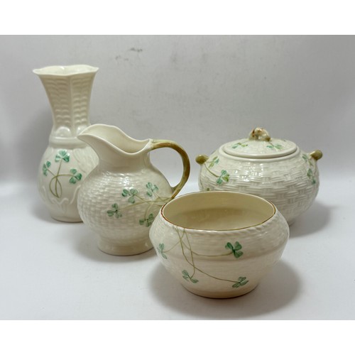  Four Pieces of Belleek pottery - including classic shamrock lidded sugar bow, Creamer Jug, open suga... 