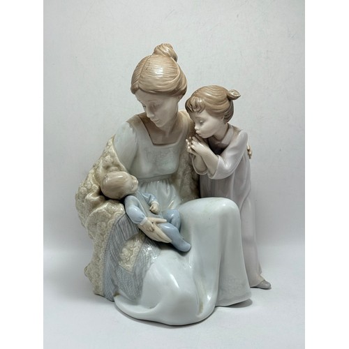  A Lladro and Nao Figurine - 'welcome to the Family' with box H24cm x W18cm plus 'Puppy Cuddles' H22c... 