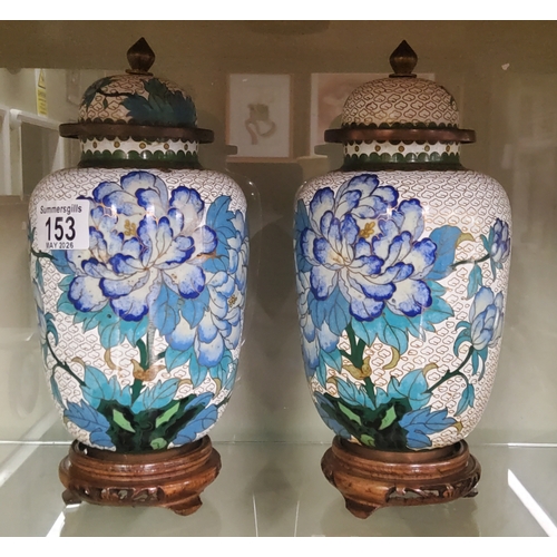  A pair of Cloisonné lidded vases with white ba kgrouns and hand painted floral motifs in blue H24cm