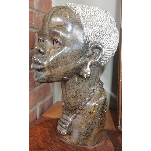  A large Shona African hard stone sculpture of a woman 35cm high