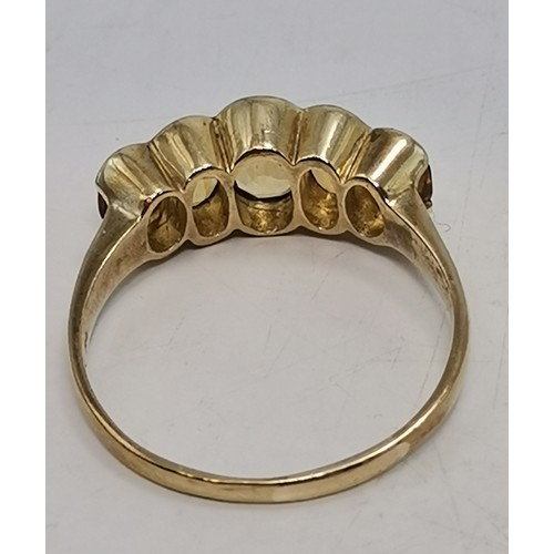 541 - Two 9 carat gold gemstone rings, the first a large oval citrine to a fancy carved c-scroll openwork ... 