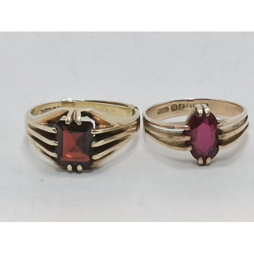  Two 9 carat gold red gemstone rings, the first a rectangular stone with cut corners, claw-mounted in... 