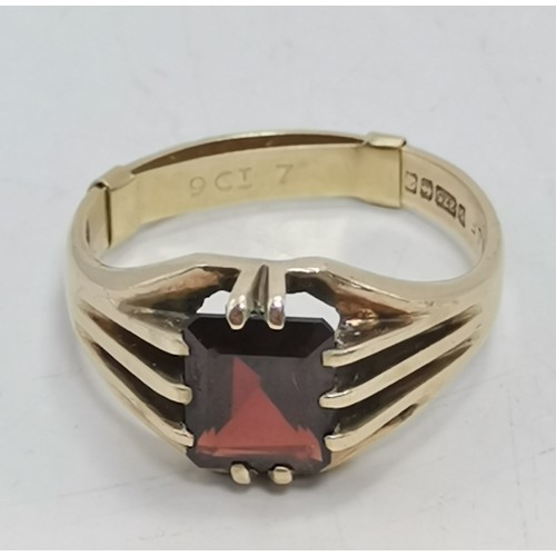  Two 9 carat gold red gemstone rings, the first a rectangular stone with cut corners, claw-mounted in... 