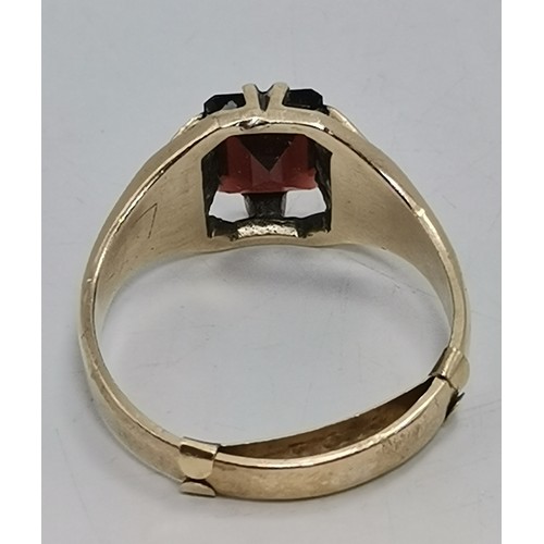  Two 9 carat gold red gemstone rings, the first a rectangular stone with cut corners, claw-mounted in... 
