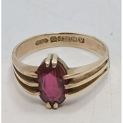  Two 9 carat gold red gemstone rings, the first a rectangular stone with cut corners, claw-mounted in... 