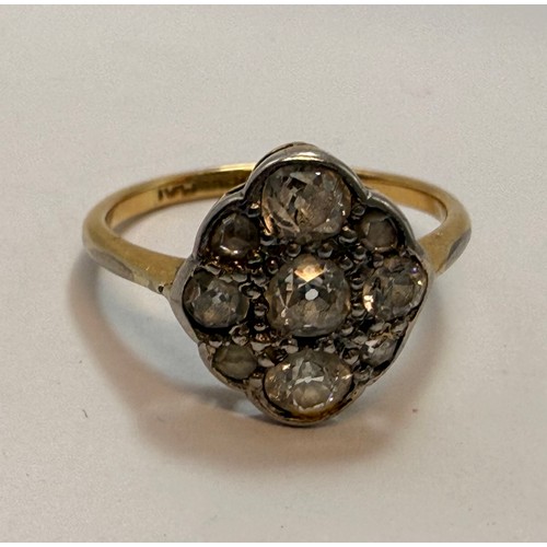 546 - A diamond cluster ring, five graduated old brilliant cut diamonds in a cross formation, with four ro... 