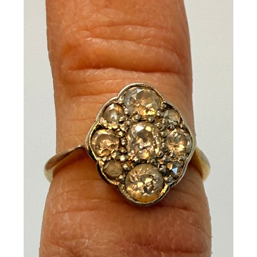 546 - A diamond cluster ring, five graduated old brilliant cut diamonds in a cross formation, with four ro... 