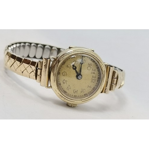  Two lady's gold expanding bracelet wristwatches, the first champagne circular dial with gilt metal A... 