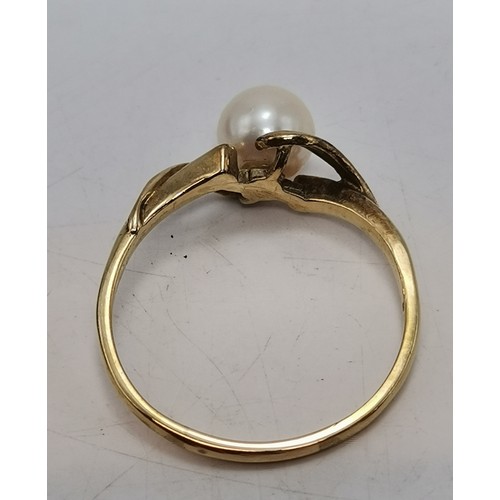  A 9 carat gold fancy pearl ring, the single pearl centred in an openwork twist mount, hallmarked Lon... 